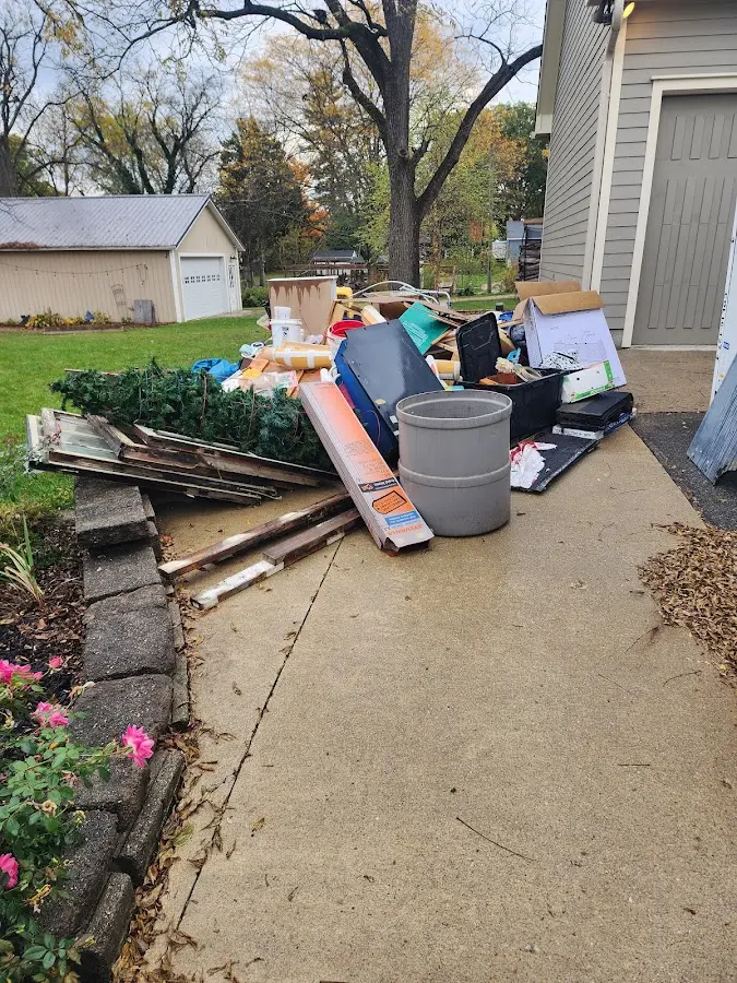 Dumpster being loaded with debris for Estate Cleanout Dumpster Rental in Fleming Island